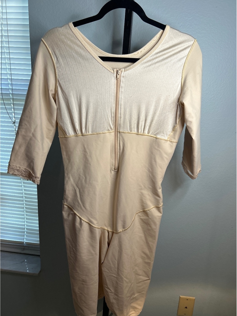 Beige One-Piece Bodysuit with 3/4 Sleeves and Front Zipper